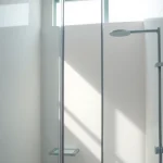 Admire douches à l'italienne with sleek glass panels and elegant tile designs.